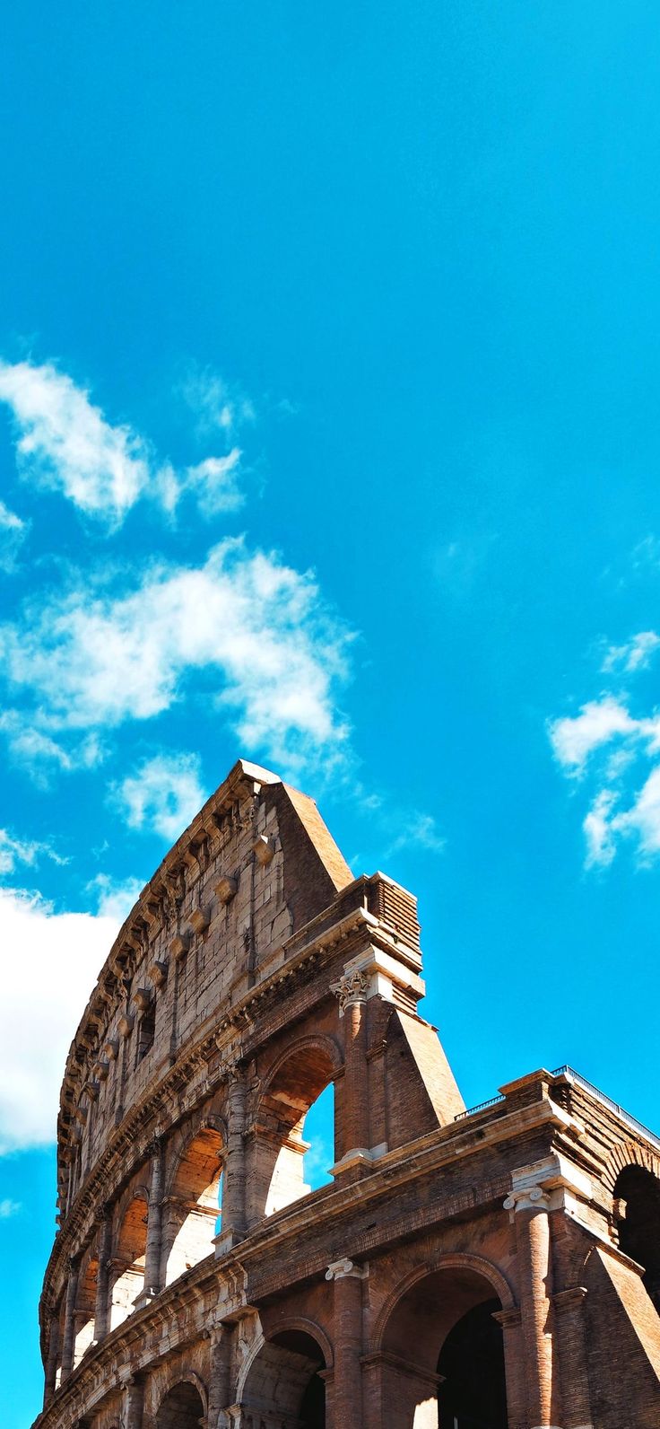 the roman colliseum is under a blue sky