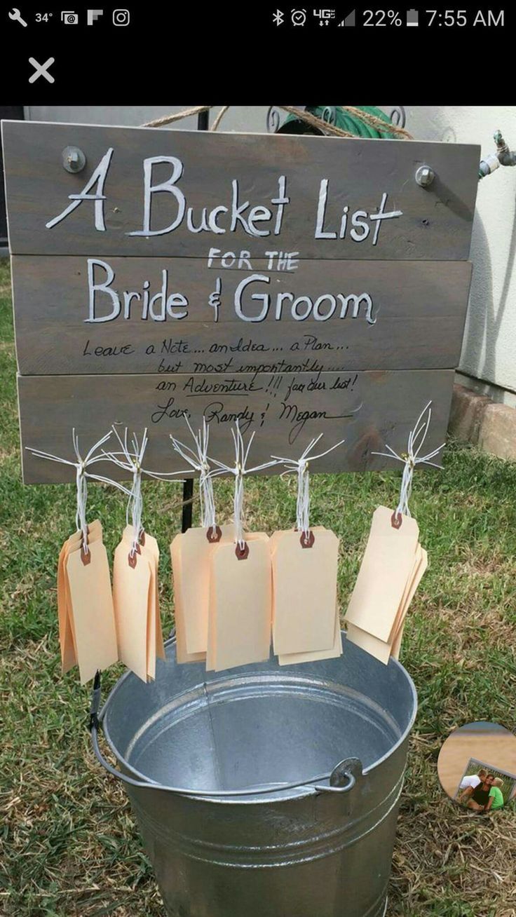 a bucket list for the bride and groom on display in front of a wooden sign