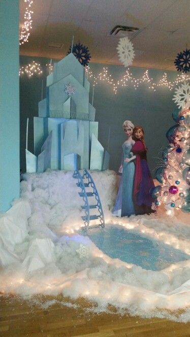 there is a fake snowman and frozen princess in the room with christmas decorations on the walls