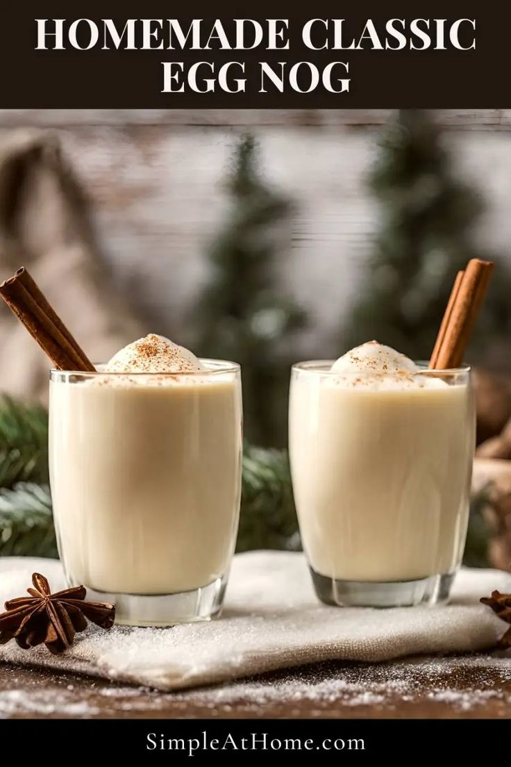 two glasses filled with egg nog on top of a white cloth next to cinnamon sticks