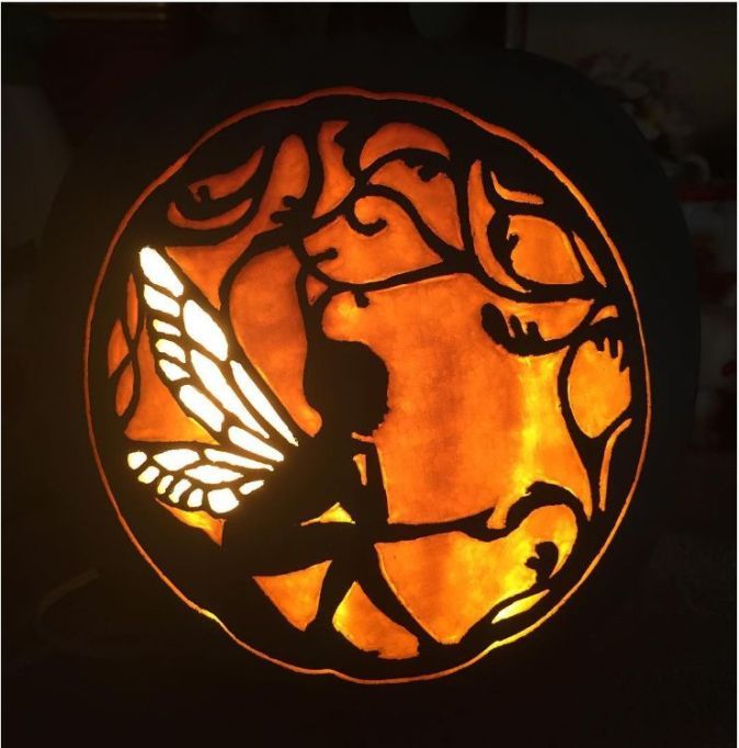 a carved glass window with a fairy on it's side and a silhouette of a child