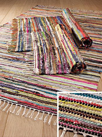 a multicolored rug with fringes on the floor