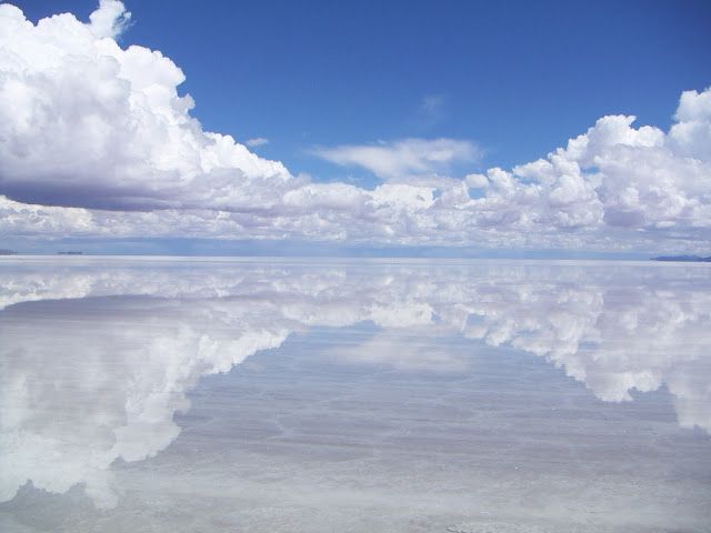 the reflection of clouds in the water is very clear and blue with no one on it