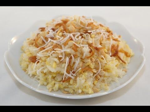 a white plate topped with rice covered in grated cheese