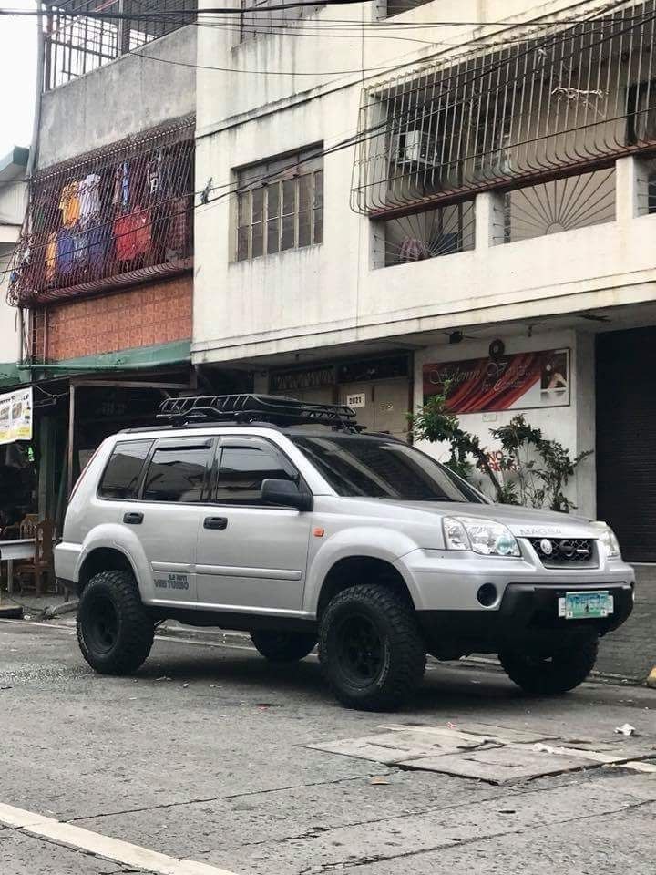 a white suv parked in front of a building