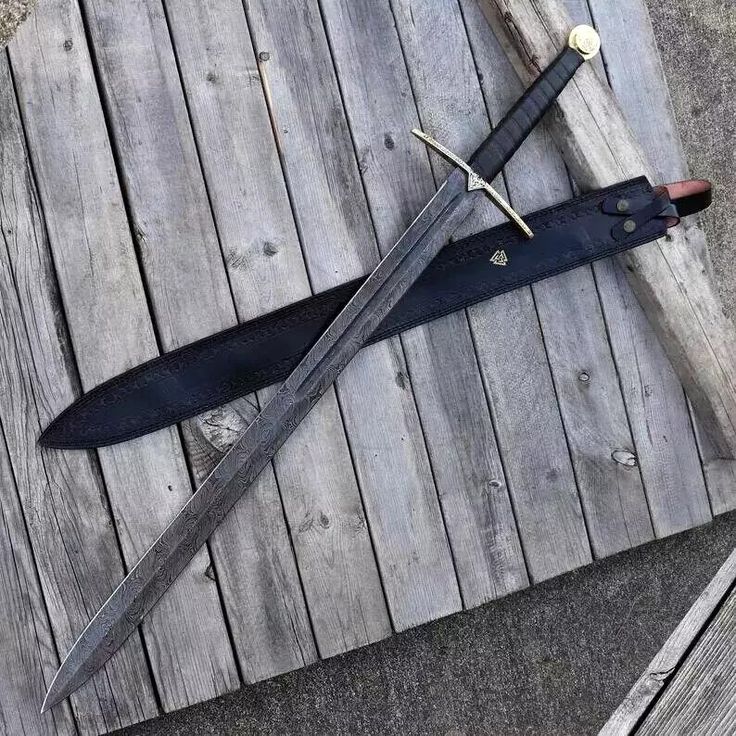 two swords are laying on top of each other, one is black and the other is red