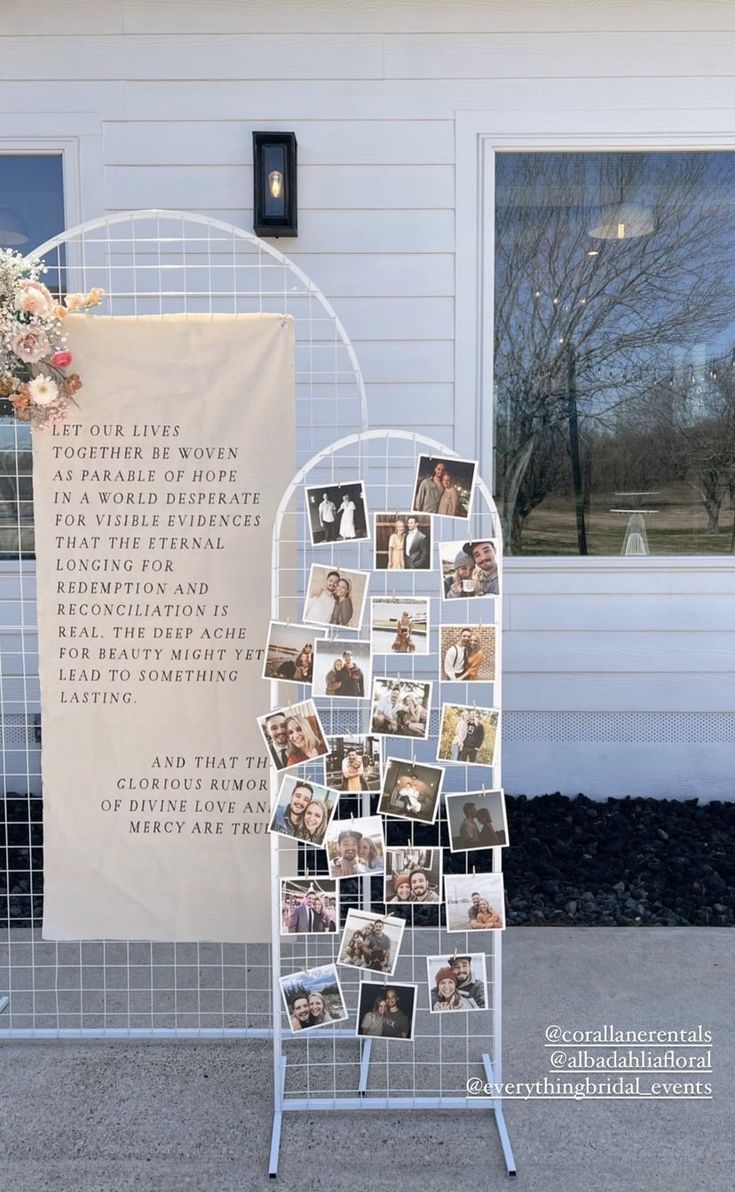 a white display with pictures on it in front of a house