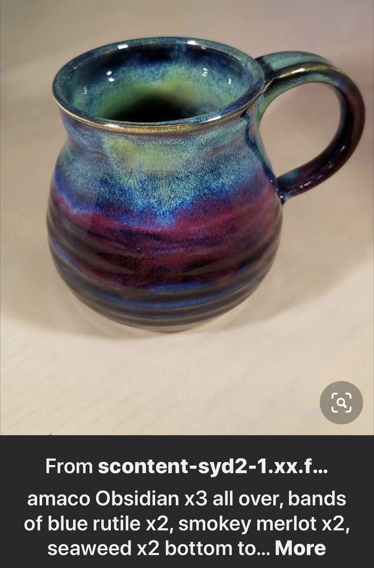 a blue and purple mug sitting on top of a table