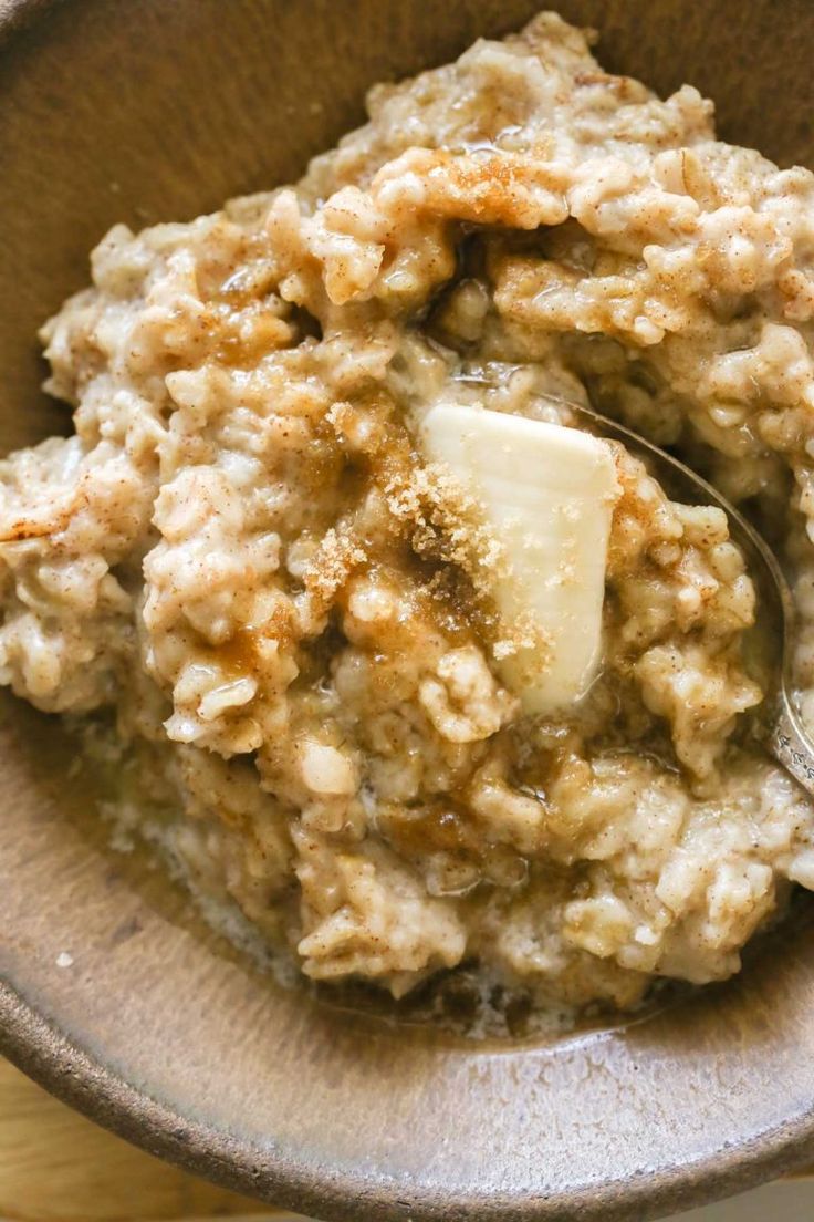 a bowl filled with oatmeal topped with butter