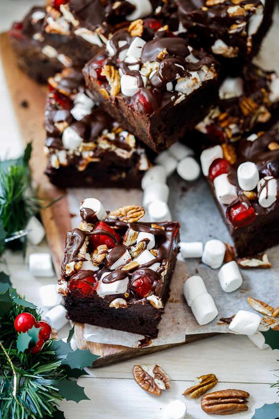 christmas brownies with marshmallows and cranberries on a cutting board