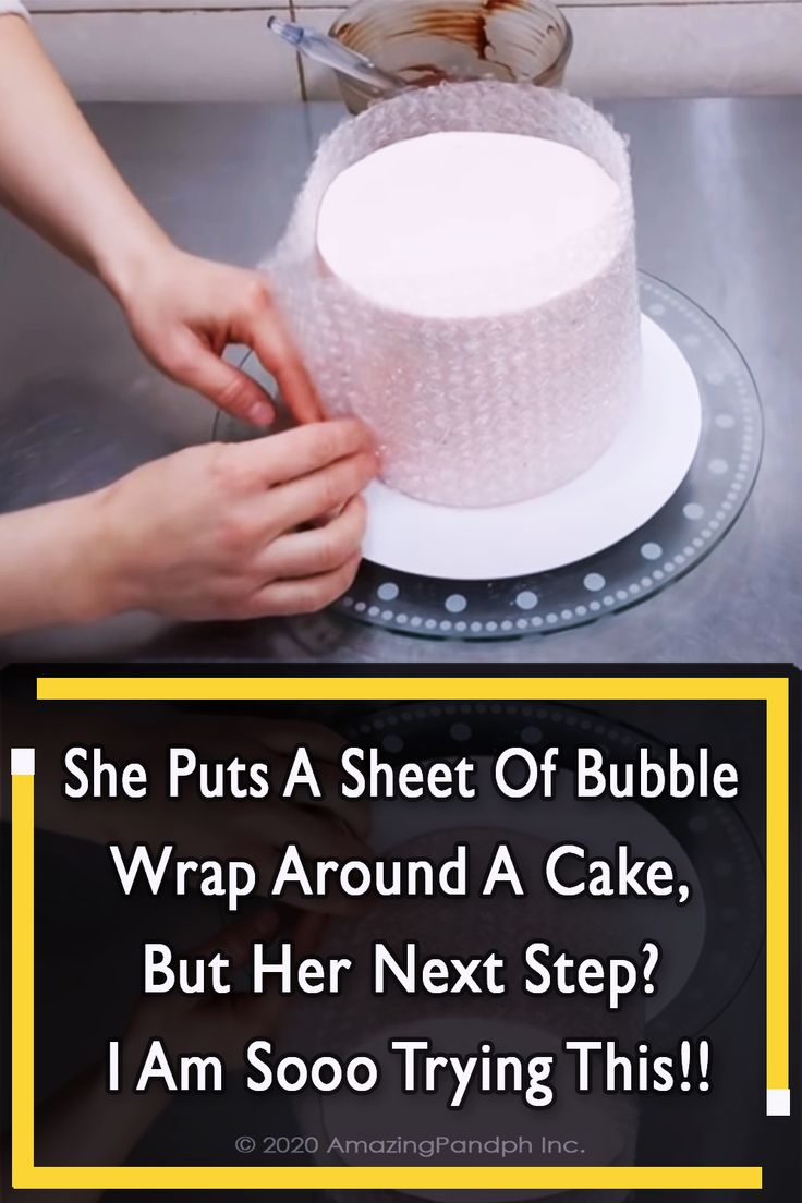 a woman is decorating a cake with white frosting