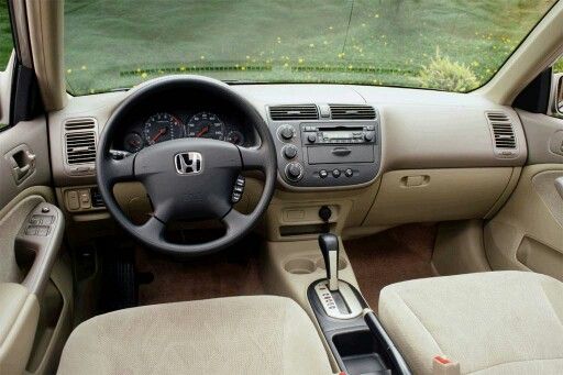 the interior of a car with beige leather seats