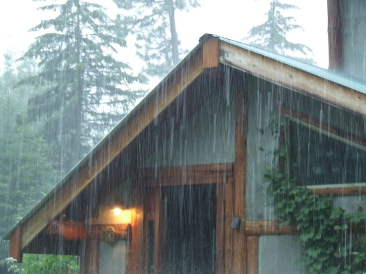 a cabin in the rain with an open door