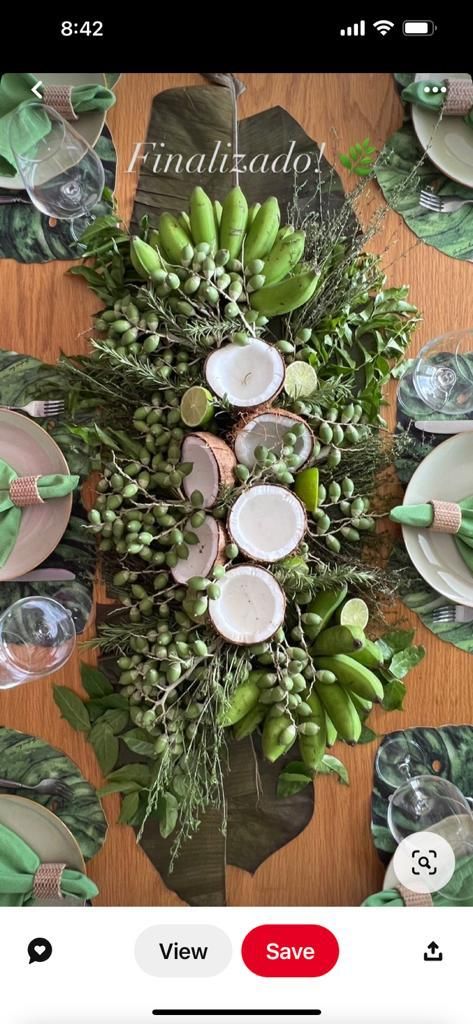 the table is set with plates, candles and greenery for an elegant dinner party