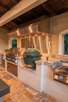 a large outdoor kitchen with an oven and grill