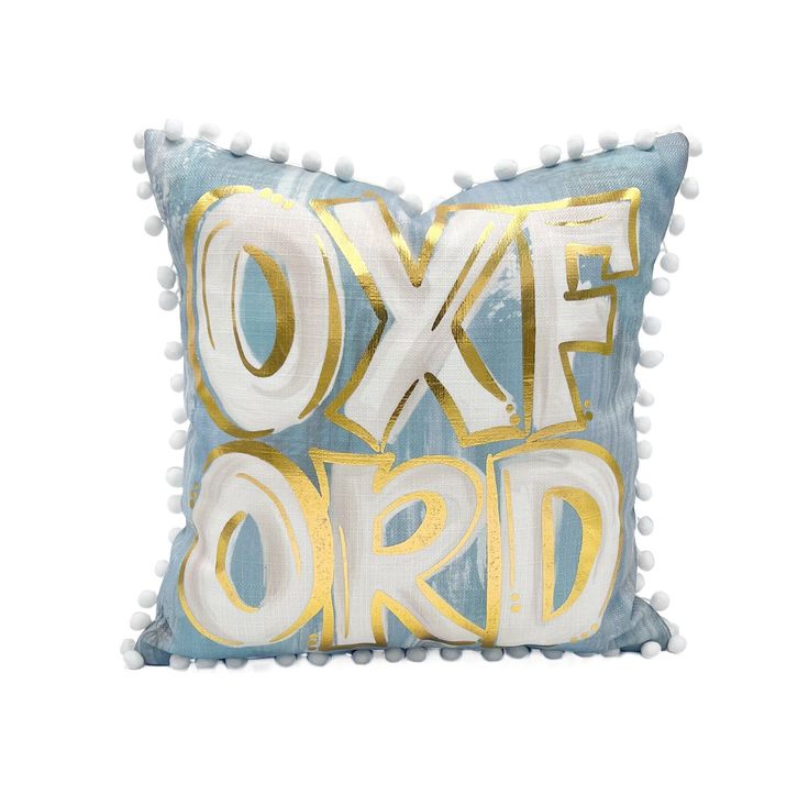 a blue and white pillow with gold foil lettering on it that says oxke lord