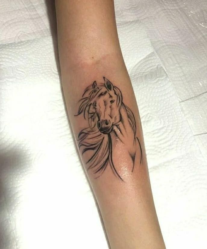 a woman's arm with a horse tattoo on it