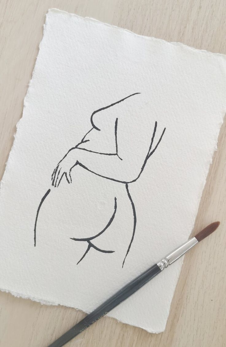 a drawing of a woman's torso on paper with a brush