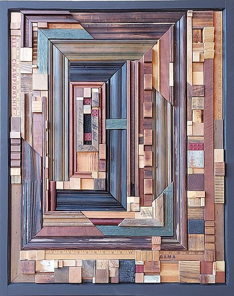 an art piece made out of wood with different colors and shapes on the sides, including squares