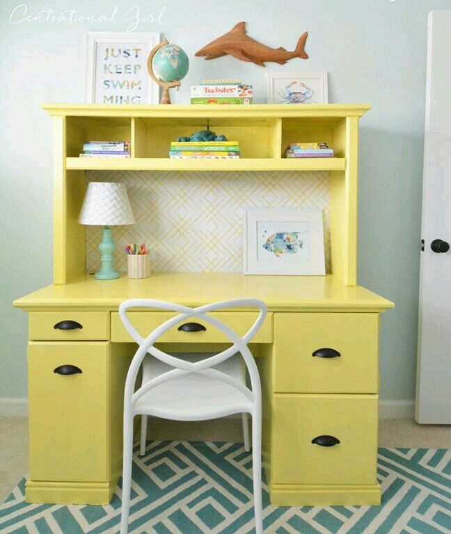 a yellow desk with a white chair next to it