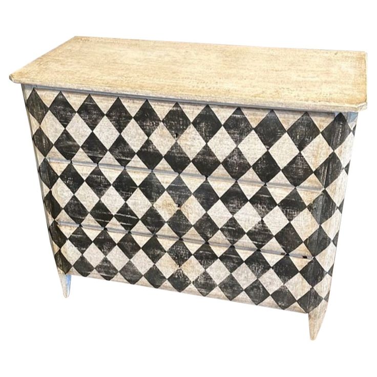 a black and white checkerboard chest with drawers on one side and an open drawer on the other