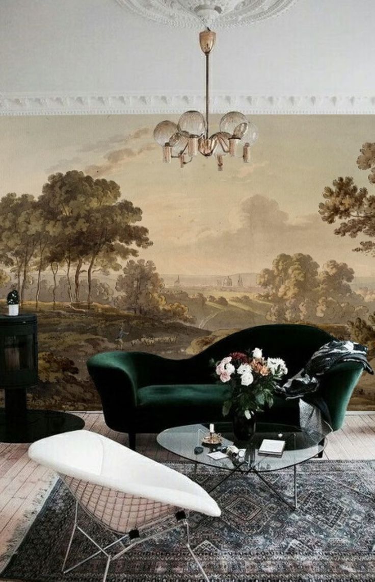 a living room filled with furniture and a painting on the wall