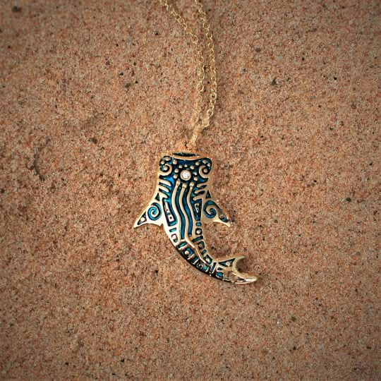 This gold and diamond Whale Shark will be hand made for you in the United Kingdom. Please allow up to 28 days for it to be completed. Blue and gold Whale Shark necklace, solid gold whale shark tattoo design pendant.This solid 9ct yellow gold whale shark pendant has been given a high-carat gold coating, decorated with a blue patina reminiscent of maritime tattoo ink and set with a brightly sparkling little diamond. The design was inspired by the art of the coastal communities that have lived in harmony with these magnificent creatures for thousands of years.Whale Sharks are the largest of all fish growing up to 14m (46 ft) long, yet they are quite harmless to humans. Swimming with Whale Sharks is often described as the highlight of many tropical adventures.This substantial pendant measures Whale Shark Necklace, Whale Shark Tattoo Design, Shark Tattoo Design, Tattoo Whale, Whale Shark Tattoo, Shark Jewelry, Gold Whale, Whale Jewelry, Shark Pendant