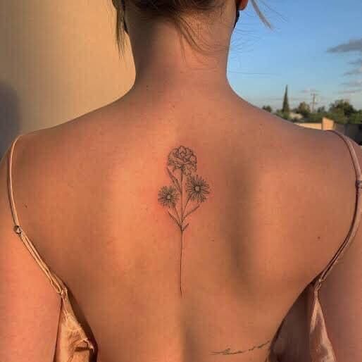 a woman with a flower tattoo on her back