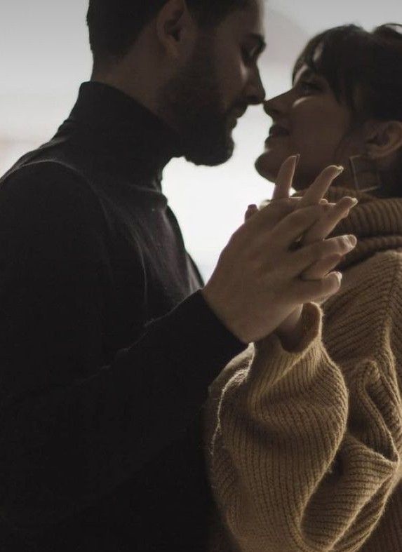 a man and woman standing next to each other