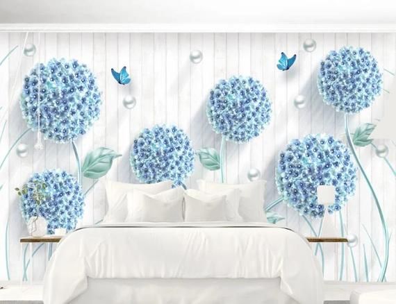 a bedroom with blue flowers and butterflies on the wall