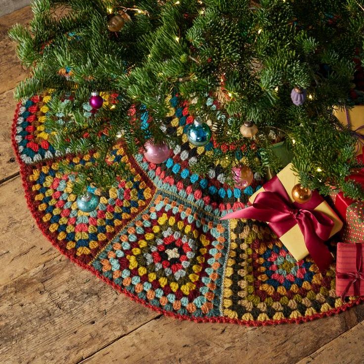 a christmas tree with presents under it on the floor