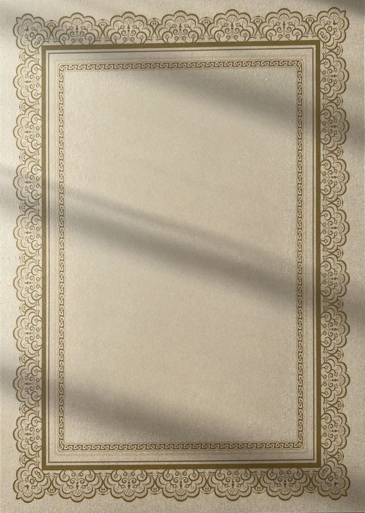 a white and beige area rug with an ornate border