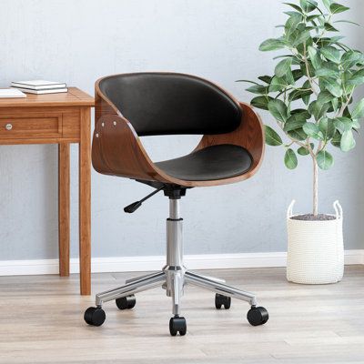 an office chair next to a small table with a potted plant on the side