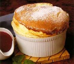 a pastry sitting on top of a white dish next to a cup