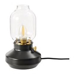 a black table lamp with a clear glass dome on it's base and gold accents