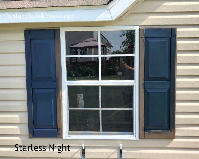 a house with blue shutters on the outside and windows in the inside that are open