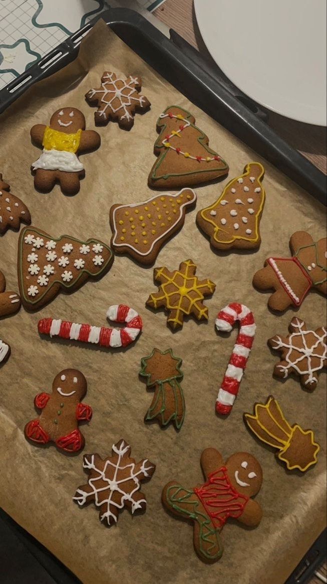 an assortment of decorated cookies sitting on top of a cookie sheet in a baking pan