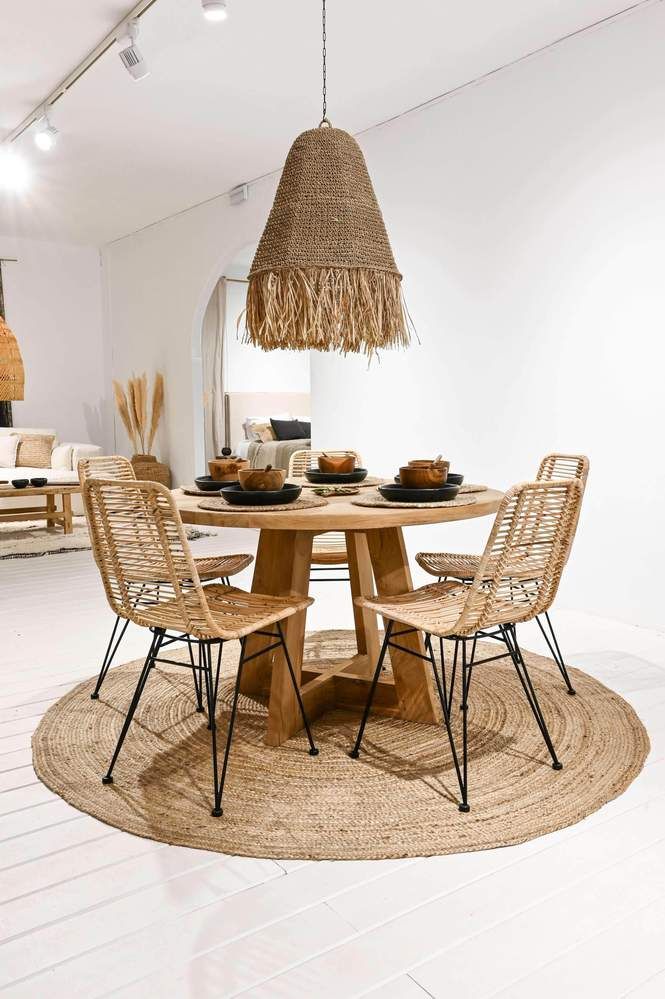 a round table with four chairs and a basket hanging from it's centerpiece