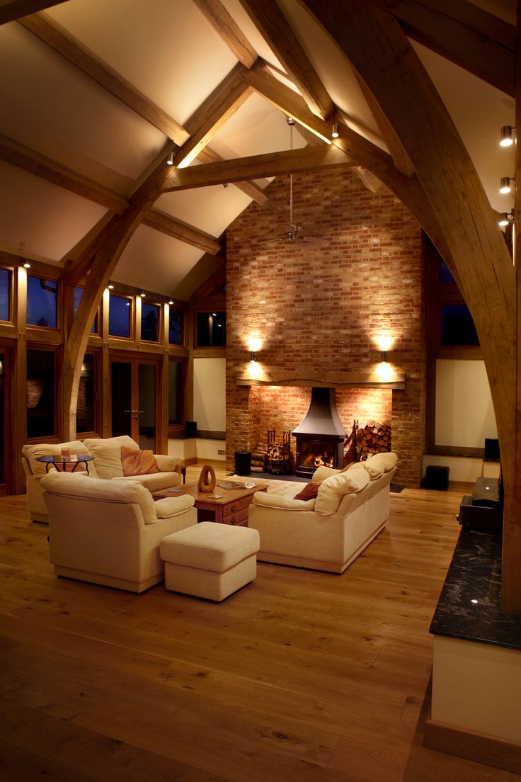 a living room filled with furniture and a fire place in the middle of a room