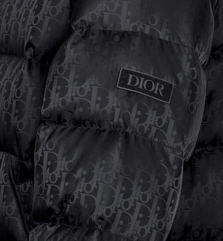 The black technical jacquard down jacket pays tribute to House heritage with a tonal Dior Oblique motif. Both modern and relaxed, it features a two-way zip closure with double pulls, a Dior soft patch on the sleeve and insulating goose down filling. The down jacket will lend a hallmark touch to any outfit.. 52 Cold Pics, Dior Clothes, Denim Swimsuit, Dior Jacket, Apparel Design Inspiration, Designer Jackets For Men, Pretty Sneakers, Dior Star, Zara Drip