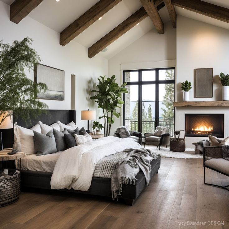 a large bed sitting in the middle of a bedroom next to a fireplace