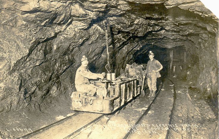 an old photo of two people in a cave