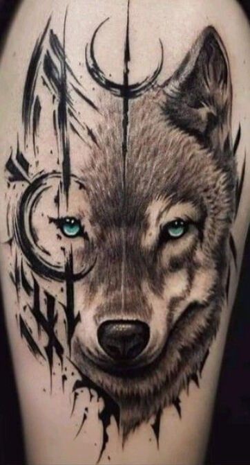 a wolf tattoo with blue eyes on the thigh