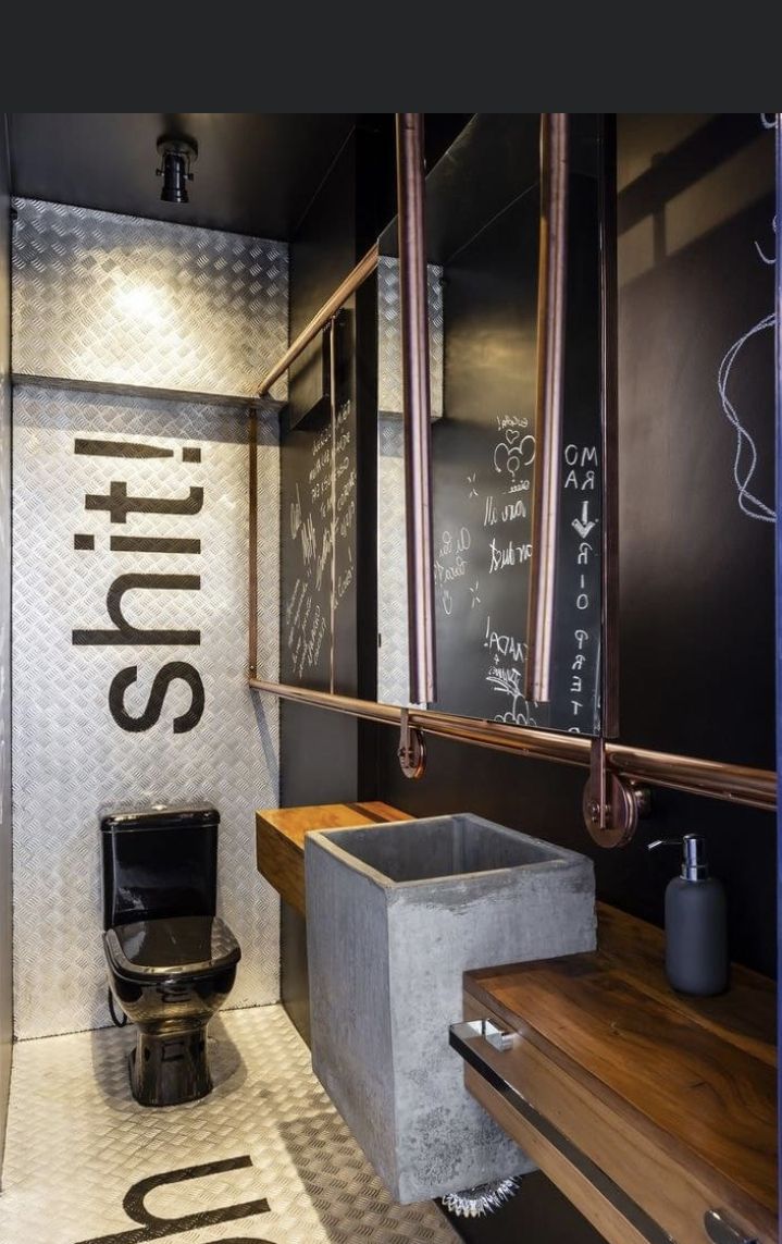 a bathroom with a toilet and chalkboard on the wall next to it's steps