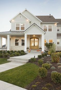 a large white house with landscaping around it