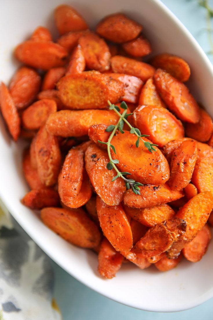 a white bowl filled with carrots on top of a table