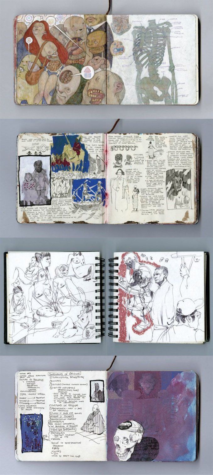 three notebooks with drawings on them sitting next to each other