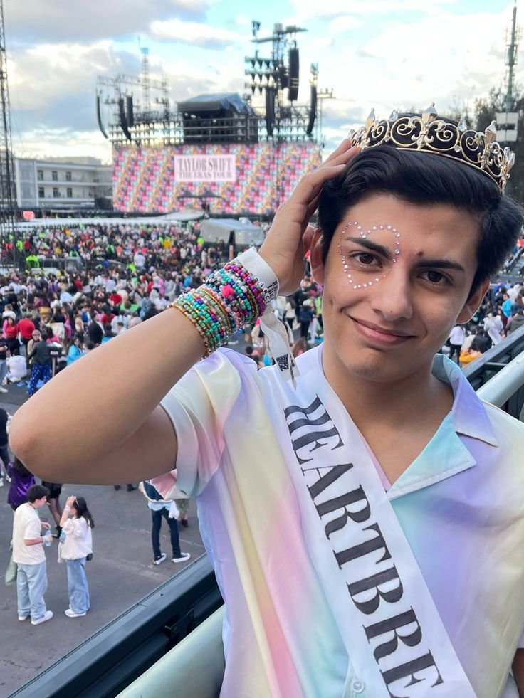 a man wearing a tiara in front of a crowd at a sporting event,