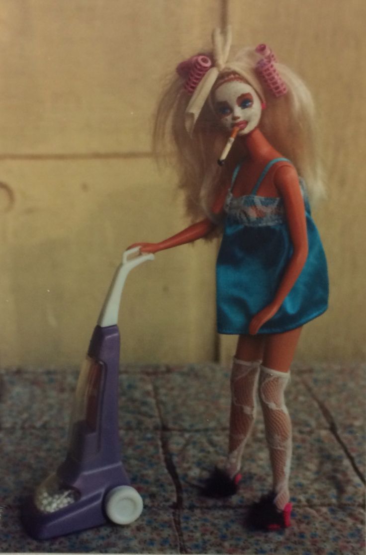 a doll is cleaning the floor with a vacuum