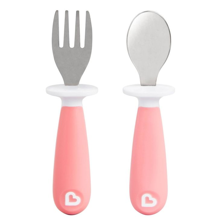 two forks and spoons sitting next to each other on a white surface with pink handles